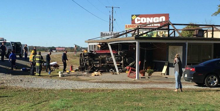 Truck Rolls Over Into Bryant Business on Interstate (Video)