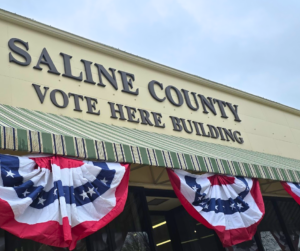 The front of the Saline County Vote Here Building is decorated with red, white and blue bunting, for election time.